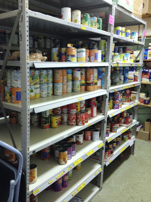 Shelving with cans of food.